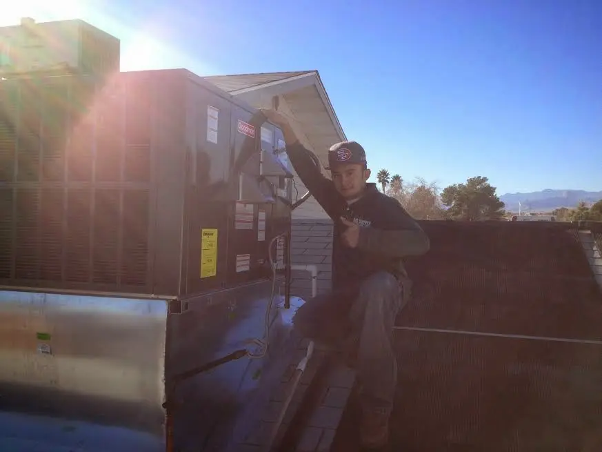 HVAC technician performing HVAC Inspection on a rooftop unit in Kings Mountain